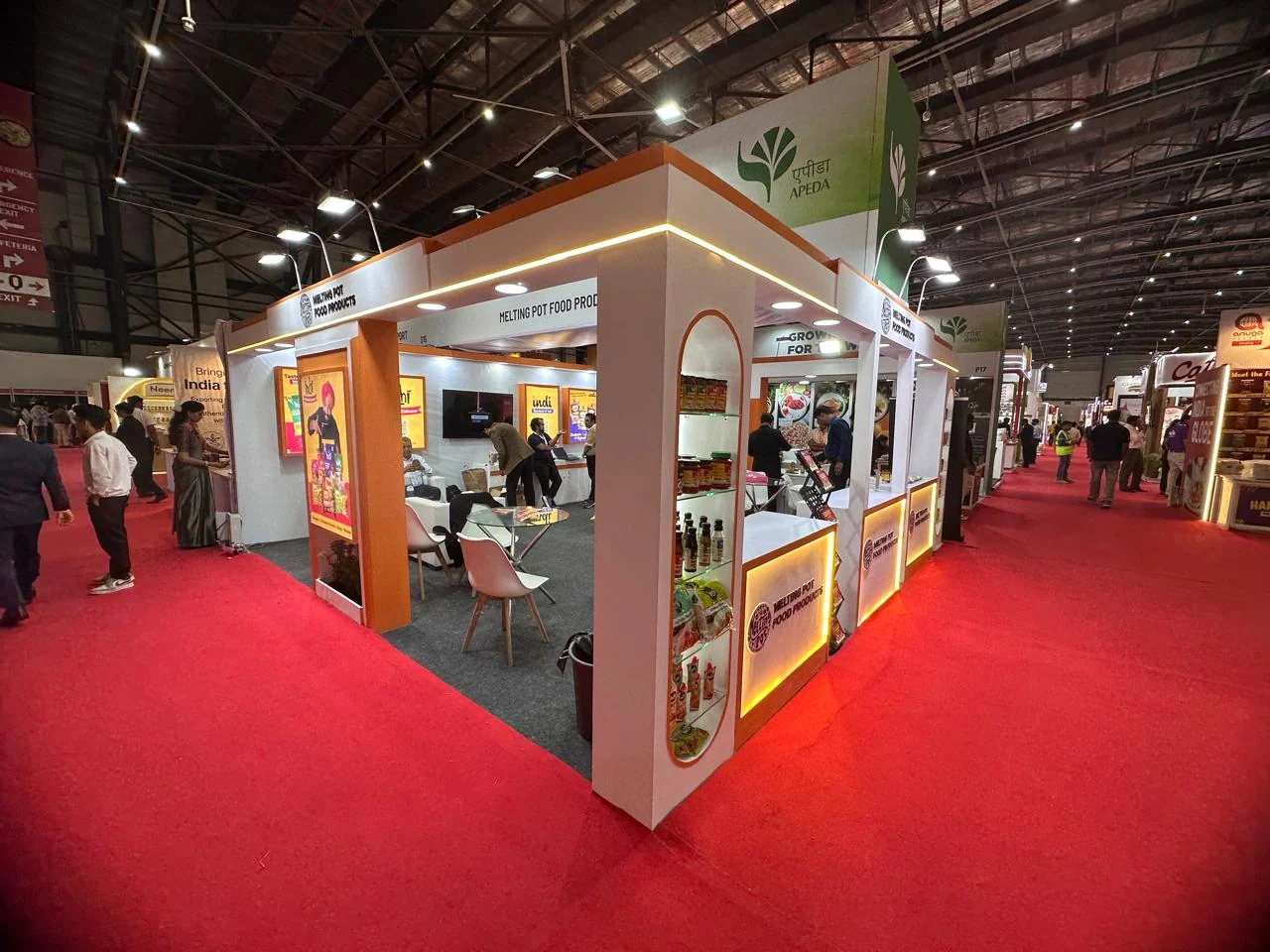Completed Melting Pot Food exhibition stall with arched product displays and illuminated counters at NESCO Mumbai